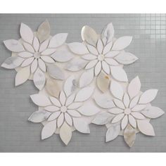 a tile wall with white flowers on it