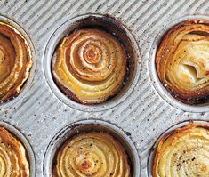 four muffin tins filled with different types of baked goods on top of a metal tray