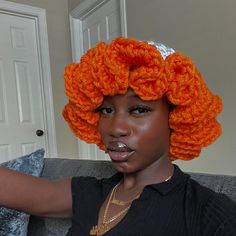 a woman with an orange wig on top of her head