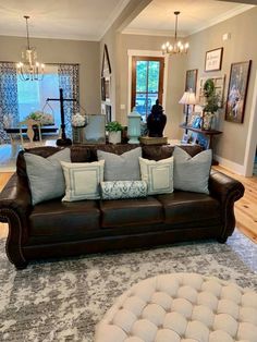 a living room filled with lots of furniture and decor on top of a carpeted floor