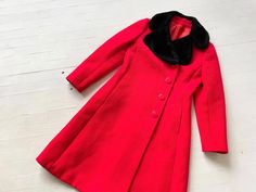 "Item details: - cherry red - black faux fur collar - feels like wool - buttons down front - pockets on hips - fitted shape - fully lined Best fits a size xs - small. Measurements: bust: 36\" waist: 33\" length: 40\" shoulder: 15.5\" sleeve: 23\" Excellent vintage condition." Classic Fitted Outerwear With Faux Fur Lining, Red Fitted Collared Outerwear, Fitted Red Wool Outerwear, Red Fitted Outerwear With Faux Fur Trim, Fitted Red Outerwear With Faux Fur Trim, Vintage Red Winter Outerwear, Red Fur Coat With Faux Fur Trim For Winter, Vintage Red Wool Outerwear, Red Fur Coat With Faux Fur Trim