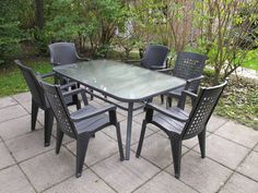 an outdoor table and chairs set up on a patio