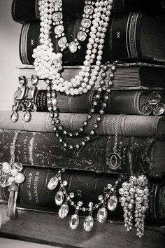 a stack of books with pearls on them