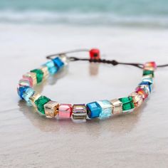 This adjustable bracelet features high-quality glass cube beads and can fit all wrist sizes. It is most suitable for wrists measuring 6-8 inches, or sizes XS through 4X. Adjustable Multicolor Crystal Glass Bracelet, Adjustable Rectangular Crystal Bracelet As A Gift, Adjustable Rectangular Crystal Bracelet For Gift, Adjustable Rectangular Crystal Bracelet Gift, Adjustable Multicolor Crystal Bracelet With Letter Beads, Adjustable Glass Beaded Bracelets As Gift, Adjustable Glass Crystal Bracelet Gift, New Bicycle, Glass Cube