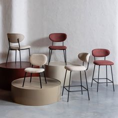 several chairs and stools in various colors