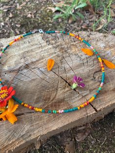 This beaded necklace features vibrant glass beads and natural coral beads. It was made with patience and love, and designed with nature as the inspiration. It has a sterling silver clasp with a handcrafted sterling silver oval jumpring for easy clasping. It measures 18.25 inches in length. Bohemian Orange Single Strand Beads, Bohemian Single Strand Oval Beaded Necklaces, Orange Oval Beaded Necklaces As Gifts, Orange Oval Beaded Necklace For Gifting, Orange Oval Beaded Necklace For Gift, Bohemian Orange Beaded Necklaces With Oval Beads, Bohemian Orange Beaded Necklace With Oval Beads, Multicolor Bohemian Beaded Necklace, Colorful Bohemian Single Strand Beaded Necklace