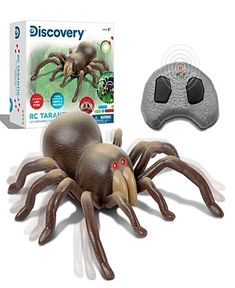 a toy spider with its eyes open next to it's packaging