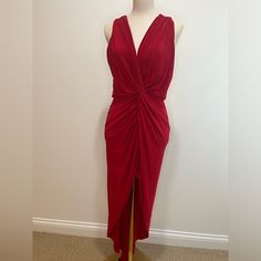 a woman's red dress on display in front of a white wall