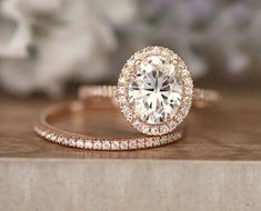 an engagement ring set with a round diamond in the center and two rows of diamonds on each band