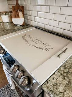 a stove top oven sitting inside of a kitchen next to a counter with utensils on it