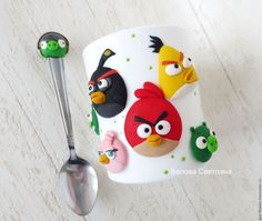 the angry birds mug is next to two spoons