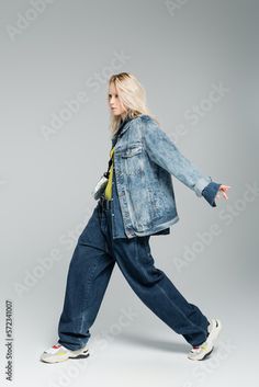 Stock Image: full length of young blonde woman in blue denim outfit and stylish sneakers walking on grey. Blue Denim Outfit, Blue Denim Outfits, Sneakers Walking, Blonde Woman, Blonde Women, Denim Outfit, Stylish Sneakers, Family Photo