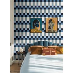 a blue and white checkered wall in a bedroom with two paintings on the wall