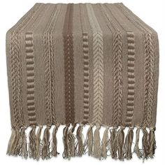 a blanket with fringes on top of it