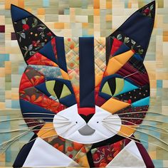 a close up of a cat made out of quilts