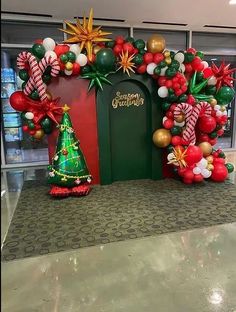 an entrance decorated with christmas decorations and balloons