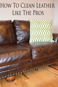 a brown leather couch sitting on top of a hard wood floor