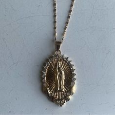 This Virgin Mary, Pendant Necklace Is Perfect For Layering W/ Your Favorite Chains For The Ultimate Mob-Wife & Y2k Aesthetic And Is Said To Offer Protection & Healing Energies, Making It A Thoughtful Gift For Those Seeking Love & Guidance. It’s Its Beauty And Significance Are Timeless. Measurements Are Included In Listing Pictures. New Without Tags. From Both A Pet Free & Smoke Free Home. Gold Chain Pendant, Virgin Mary Pendant, Virgin Mary Necklace, Angel Necklace, Mob Wife, Gold Chain With Pendant, Catholic Jewelry, Hail Mary, Chain Pendant