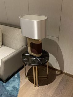 a table with a lamp on it next to a couch