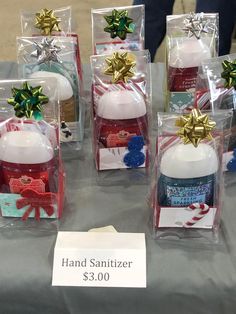 several christmas ornaments are on display in clear plastic bags with bows and tags attached to them