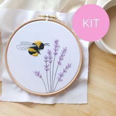 a cross stitch bee with lavender flowers on it