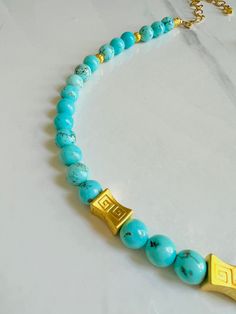 Our Antigua Turquoise Beaded necklace is a breath of fresh air, with brilliant blue hues that are reminiscent of the waters in Antigua. We're now offering in matte gold as well as shiny gold. Etched gold beads offer a striking contrast and we've added some chain so you can adjust the length. Necklace measures 18” in length with lobster clasp closure and is free from cadmium, lead, and nickel. Please note every batch of turquoise varies in color. Gold Turquoise Necklace With Polished Beads As Gift, Gold Turquoise Necklace With Round Gemstone Beads, Gold Turquoise Necklace With Gemstone Beads For Spiritual Style, Gold Turquoise Necklace With Round Beads For Gift, Gold Turquoise Necklace With Round Beads As A Gift, Spiritual Gold Turquoise Necklace With Gemstone Beads, Gold Turquoise Necklace With Round Beads And Natural Stones, Gold Turquoise Necklace With Polished Beads, Gold Turquoise Necklace For Healing And Spirituality