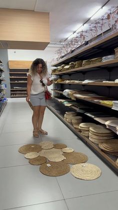 a woman is looking at the floor in a store