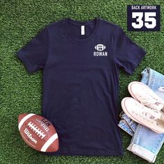 Football graphic with number inside, and name underneath along with number on the back on the t-shirt. Child's name and football numbers are customizable! Graphic color varies on t-shirts. Customization:Message us with your order number and the player's name and number. Custom orders take 1-2 weeks. Adult Sizes S-XXL (unisex sizing) For Custom Adult & Youth Sweatshirt click here to view.Bella + Canvas4.2 oz. Airlume combed and ring-spun cottonPre-shrunkFor a more relaxed fit, size up! Collegiate T-shirt With Name Print For Team Events, Collegiate T-shirt With Name Print For Fans, Team Spirit T-shirt For Football Season Team Events, Football Season Team T-shirt, Sporty T-shirt For Football Season Team Events, Crew Neck T-shirt For Football Season Team Events, Football Season Team Events T-shirt, Football Season Team Event T-shirt, Team Spirit T-shirt For Football Season