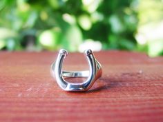 "This BEAUTIFUL Handcrafted .925 Sterling Silver Horseshoe ring - Equestrian Jewelry - Horseshoe Jewelry - for everyday wear or going out on the town. Great for horse lover gifts, Equestrian gifts, Horse gifts. *Sterling Silver * Measument of Horseshoe : 5/8\" by 1/2\" * Size 6-11 * 925 Sterling Silver I have many more unique Handcrafted Sterling Silver Jewelry Pieces that I will be selling here on Etsy so check back!! You will be happy you did. Go back to my home page: https://www.etsy.com/shop Equestrian Ring, Horse Lover Gifts, Equine Jewelry, Horseshoe Jewelry, Horse Ring, Horseshoe Ring, Horseshoe Pendant, Equestrian Jewelry, Equestrian Gifts