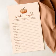 a notepad with words and a pumpkin on it next to a peach colored blanket