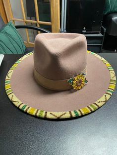 Felt fedora style Panama hat with beaded brim and decorative hat band. Western Beaded Hats For Spring, Artisan Beaded Fedora Hat, Beaded Brown Wide Brim Hat, Brown Beaded Wide Brim Hat, Brown Wide Brim Beaded Hat, Western Beaded Fedora With Curved Brim, Beaded Hats With Curved Brim For Western-themed Events, Beaded Fedora Hats For Country Events, Beaded Fedora For Country Events