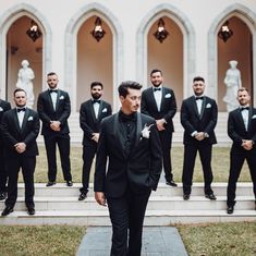 a group of men in tuxedos standing on steps