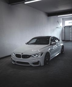 a white car parked in a parking garage