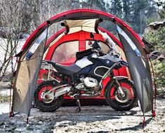 a motorcycle is parked in front of a tent