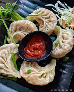 dumplings with sauce and vegetables on a plate