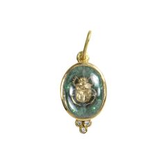 Solid yellow gold scarab charm surrounded by hand painted dark green enamel and a white sapphire crystal dome. 18K yellow gold Diamonds White sapphire crystal dome Double-sided Dimensions: 7/8” x 1/2” Charm Only Green Enamel Jewelry With Charms, Green Vintage Charm Brass Jewelry, Vintage Charm Green Brass Necklaces, Yellow Gold Vintage Charm Metal Charms, Gold Enamel Vintage Charm, Diamond Charm, Green Enamel, White Sapphire, Mens Wedding Rings