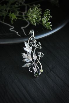 ITEM DESCRIPTION: The size H 5 cm x W 3 cm (2 x 1 1/3 inch). Weight - 5 g. You can buy it with a silver chain or without it. Even simple plants look very elegant. I made one of sterling silver, pretty green tourmaline, and peridot. This unique botanical jewelry looks like a real treasure of wild forest. It is really worthy of being in your precious collection. Expect many compliments on this! This handmade necklace will come to you in a gift box - ready for gifting. The parcel will be sent durin Green Sterling Silver Flower Pendant Jewelry, Nature-inspired Silver Metal Necklace, Nature-inspired Sterling Silver Leaf Necklace, Nature-inspired Leaf Shaped Sterling Silver Necklace, Silver Nature-inspired Metal Jewelry, Nature-inspired Silver Metal Jewelry, Silver Nature-inspired Round Pendant Jewelry, Silver Leaf-shaped Sterling Silver Necklace, Silver Round Pendant Jewelry With Nature-inspired Style