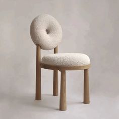 a chair with a donut shaped back rest on it's seat and legs