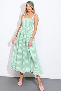 This exquisite woven midi dress boasts a timeless striped design, complete with a graceful straight neckline and delicate shoulder straps. The full skirt and smocked back bodice create a flattering silhouette, while the bare lower back adds a touch of alluring charm.Details:Self : 50% Polyester 50% CottonLining : 100% PolyesterSize & Fit- Model is 5`8" And Wearing Size Small- Measurements Taken From Size Small- Approx. Length: 52" Green Sundress With Smocked Back, Green Spaghetti Strap Dress With Smocked Back, Green Midi Dress With Smocked Back For Summer, Green Spaghetti Strap Dress With Smocked Bodice, Green Dress With Smocked Bodice And Spaghetti Straps, Green Midi Dress With Smocked Back For Garden Party, Striped Midi Dress With Smocked Bodice, Green Sleeveless Midi Dress With Smocked Bodice, Spring Green Midi Dress With Smocked Bodice