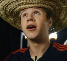 a man wearing a sombrero looking up at something