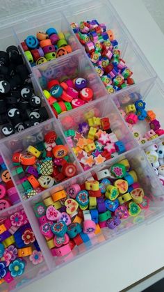 a plastic container filled with lots of different colored buttons