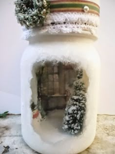 a snow covered jar sitting on top of a table