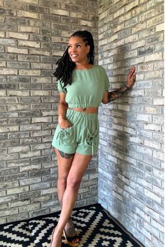 Stay cool and stylish with our Garden Party Short Set. This elevated casual set features a lightweight, non-see-through fabric, providing both comfort and breathability. The set includes a cropped top and matching shorts with slouchy front pockets for added cuteness. Details Material: 97% Polyester, 3% SpandexColor: Sage GreenFeatures: Elastic band, front pockets, lightweight, non-see-throughTop: Cropped with elastic bandShorts: Elastic waistband with front pocketsFit: True to sizeModel: Erin is wearing a size small Enjoy comfort and style with the Garden Party Short Set, perfect for any casual occasion where you want to look effortlessly put together. Trendy Relaxed Fit Crop Top For Vacation, Summer Loungewear Sets With Pockets, Spring Crop Top With Elastic Waistband Suitable For Summer, Spring Crop Top With Elastic Waistband, Summer Crop Top With Elastic Waistband For Vacation, Casual Short Sleeve Short Set, Casual Short Set With Relaxed Fit, Casual Relaxed Fit Short Set, Spring Vacation Crop Top With Elastic Waistband