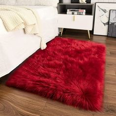 a red rug on the floor in a bedroom