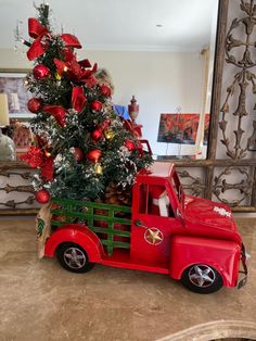 a red truck with a christmas tree in the back