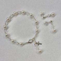 Enjoy 10% off as I celebrate 10 years on Etsy! This lovely First Communion bracelet and earrings set is sure to be the perfect gift! The beautiful bracelet also doubles as a single decade rosary. This classic bracelet has been a big seller as First Communion jewelry, Confirmation jewelry, Easter bracelet, Flower Girl gift, Maid-of-Honor jewelry, Bridesmaids matching bracelets, Mother-of-the-Bride jewelry, Godmother gift, and as Bridal jewelry. Description: -Bracelet measures 5 ½ inches plus a 1- Elegant Adjustable Rosary Bracelet For First Communion, Elegant Silver Beaded Bracelets For First Communion, Silver Round Beads Jewelry For First Communion, Classic Adjustable Jewelry For First Communion, Elegant Sterling Silver Jewelry For First Communion, Dainty Hypoallergenic Jewelry For First Communion, Adjustable Round Beads Jewelry For First Communion, White Bracelet For First Communion, White Bracelet Jewelry For First Communion