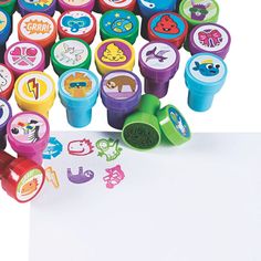 a pile of colorful rubber stamps sitting on top of a white paper next to each other