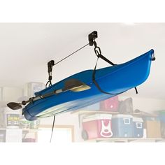 a blue kayak hanging from the ceiling