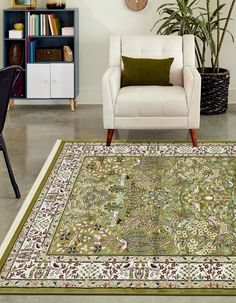 a living room with a chair, rug and bookshelf on the floor in front of it