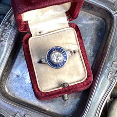 Details: Stunning vintage Art Deco style diamond & sapphire engagement ring. The band is platinum. This is an gorgeous ring with lovely engraving around the shoulders of the band, and has engraving details surrounding the diamond. This ring is stunning! Appraisal Reads: One old European cut diamond, measuring 5.8 x 5.8 x 3.55mm an approx. weight .73ct. with strong blue fluorescences. Clarity VS-2 Color J Cut Very Good Depth 61.2% Table 60.3% Two round brilliant cut diamonds measuring 1.5 x 1 Vintage 14k White Gold Sapphire Ring With Round Cut, Vintage Sapphire Ring With Diamond Cut, Vintage Platinum Sapphire Promise Ring, Vintage White Gold Sapphire Ring With Brilliant Cut, Vintage Platinum Sapphire Ring For Promise, Vintage Sapphire Ring With Center Stone For Anniversary, Vintage Sapphire Diamond Ring, Vintage Sapphire Ring In 14k White Gold, Vintage 14k White Gold Sapphire Ring With Center Stone